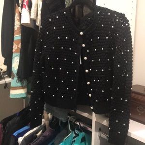 Black sweater with pearls.